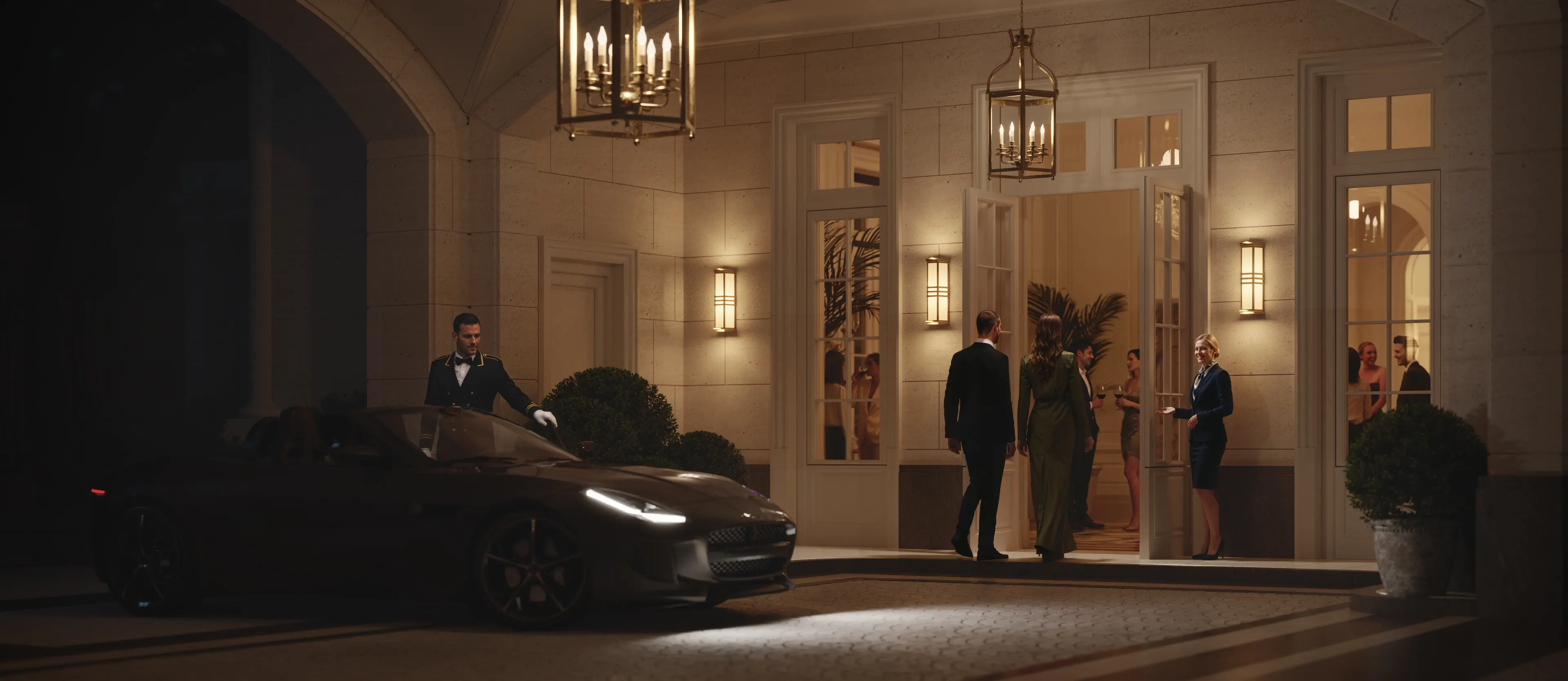 Guests arriving at the porte-cochère at night